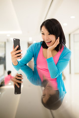 Woman using cellphone to take selfie