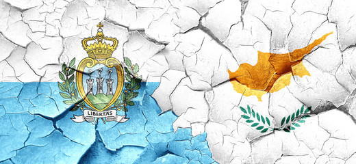 san marino flag with Cyprus flag on a grunge cracked wall