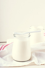 organic dairy products (yogurt, sour cream) in a glass jar