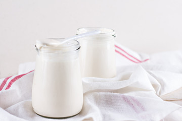 organic dairy products (yogurt, sour cream) in a glass jar