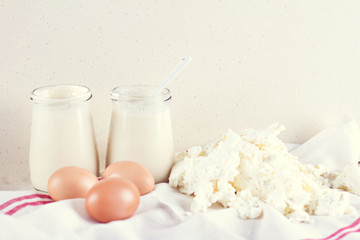 natural yoghurt in a glass jar, eggs and cheese. ingredients for baking