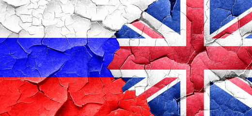 Russia flag with Great Britain flag on a grunge cracked wall