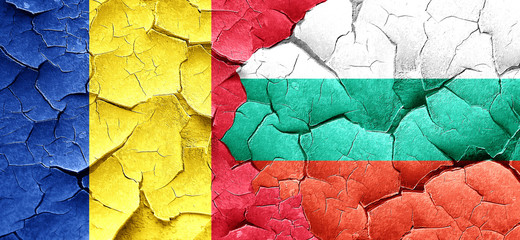Romania flag with Bulgaria flag on a grunge cracked wall