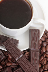 Coffee cup and chocolate on a white background