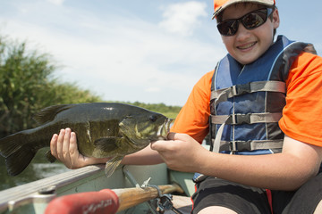 A young fisherman with a Small Mouth Bass