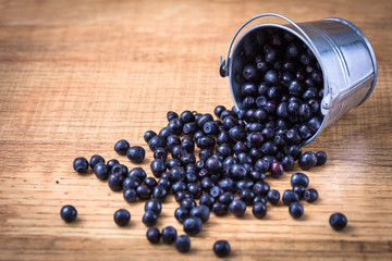 Blueberry on wooden table background. Ripe and juicy fresh picke