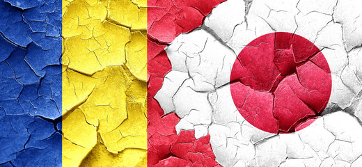 Romania flag with Japan flag on a grunge cracked wall