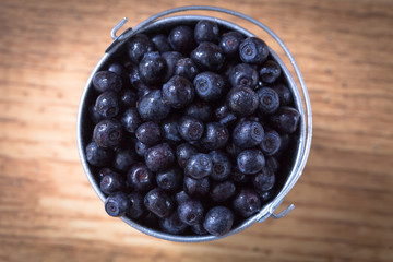 Blueberry on wooden table background. Ripe and juicy fresh picke