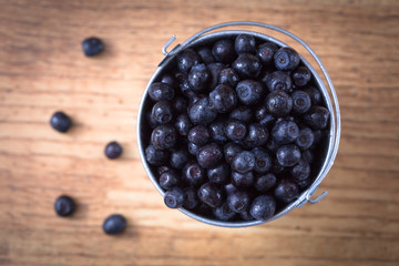 Blueberry on wooden table background. Ripe and juicy fresh picke