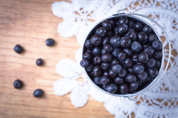 Blueberry on wooden table background. Ripe and juicy fresh picke