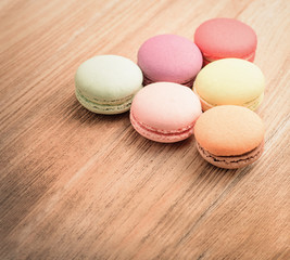 Obraz na płótnie Canvas Colorful French Macarons on wooden background