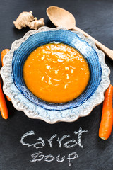 carrot soup flavored with ginger over slate background