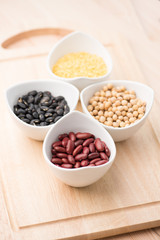 four colored beans in ceramic bowl