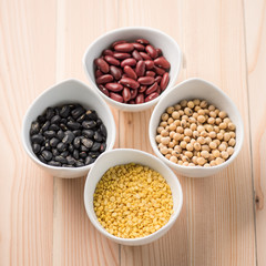 four colored beans in ceramic bowl