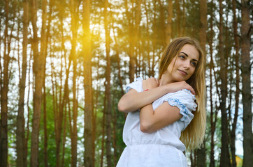 Portrait of beautiful young woman in pine forest