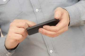 Texting on a smartphone. Shallow depth of field.