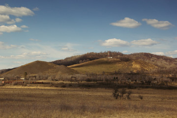 Obraz premium Hill and the yellow field on a clear day. Early spring, autumn. Landscape.