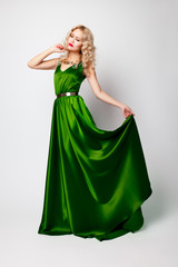 Beautiful woman model posing in green dress