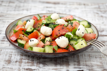 salad of fresh organic vegetables with mozzarella cheese and bla