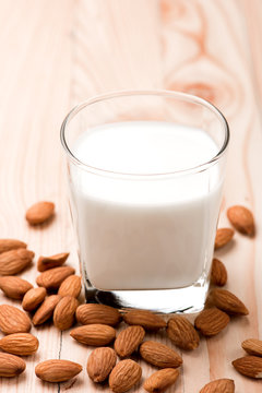 Almond milk in a glass with almonds