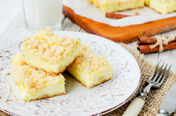
rustic grated cheese cake with berries , with blueberries and milk on a wooden background