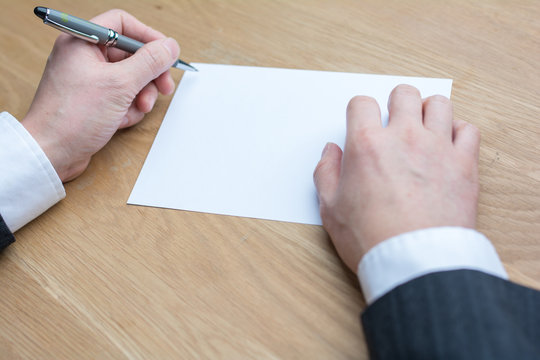 businessman writing on white paper