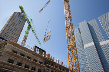 Crane lifting a wall on a construction site