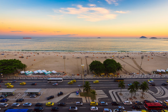 Sunset view of Copacabana beach and Avenida Atlantica in Rio de Janeiro, Brazil