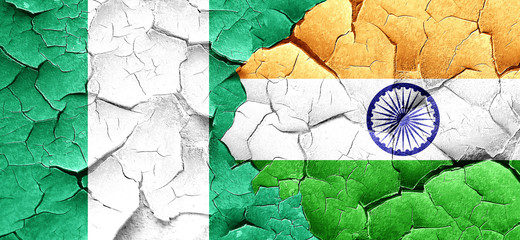 Nigeria flag with India flag on a grunge cracked wall