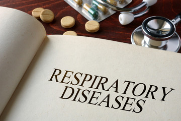 Book with diagnosis respiratory diseases and pills. Medical concept.