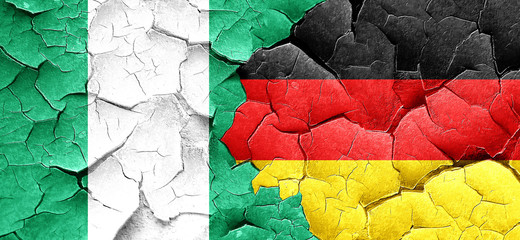 Nigeria flag with Germany flag on a grunge cracked wall