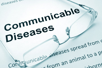 Paper with words  communicable diseases  and glasses.