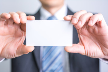 Fototapeta premium businessman holding white blank paper
