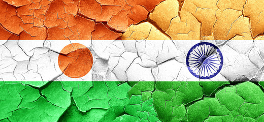 niger flag with India flag on a grunge cracked wall