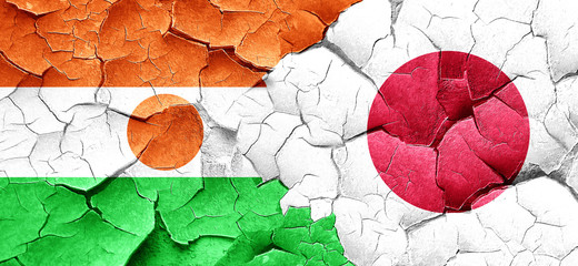 niger flag with Japan flag on a grunge cracked wall