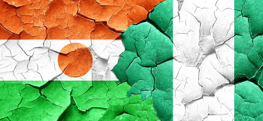 niger flag with Nigeria flag on a grunge cracked wall
