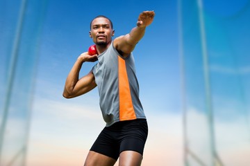sportsman practising shot put 