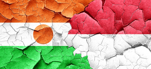 niger flag with Indonesia flag on a grunge cracked wall
