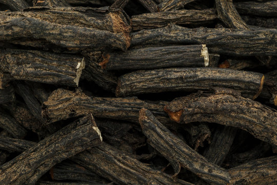 Organic dry True comfrey (Symphytum officinale) roots. Macro close up background texture. Top view.