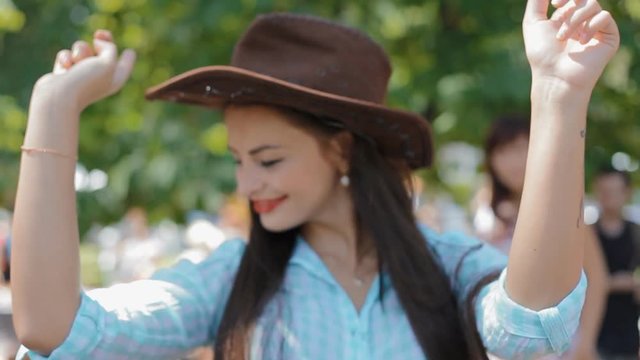 American woman dance with leather hat.Western style.