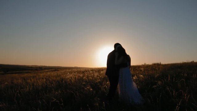 Bridal couple in sunset sun