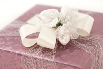 Fototapeta na wymiar Purple pink paper wrap white creamy ribbon bow gift box present christmas birthday wedding elegance isolated