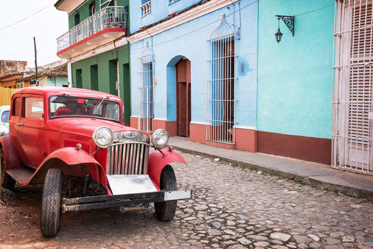 Old vintage car in a paved street of Trinidad, Cuba