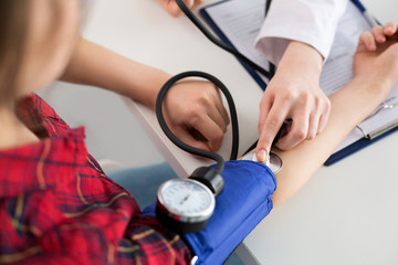 Close up view of doctor measuring blood pressure