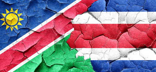 Namibia flag with Costa Rica flag on a grunge cracked wall