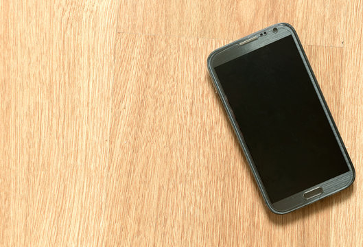 Smartphone on the wooden floor