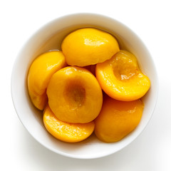 Naklejka na ściany i meble Canned peach halves in bowl isolated on white background. From a