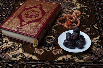 Naklejka na ściany i meble Date on plate and Koran on carpet