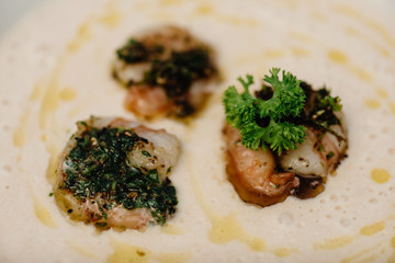 Potato creme soup with salmon and shrimps