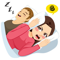 Woman covering ears with white pillow while man is making loud noise snoring in bed
